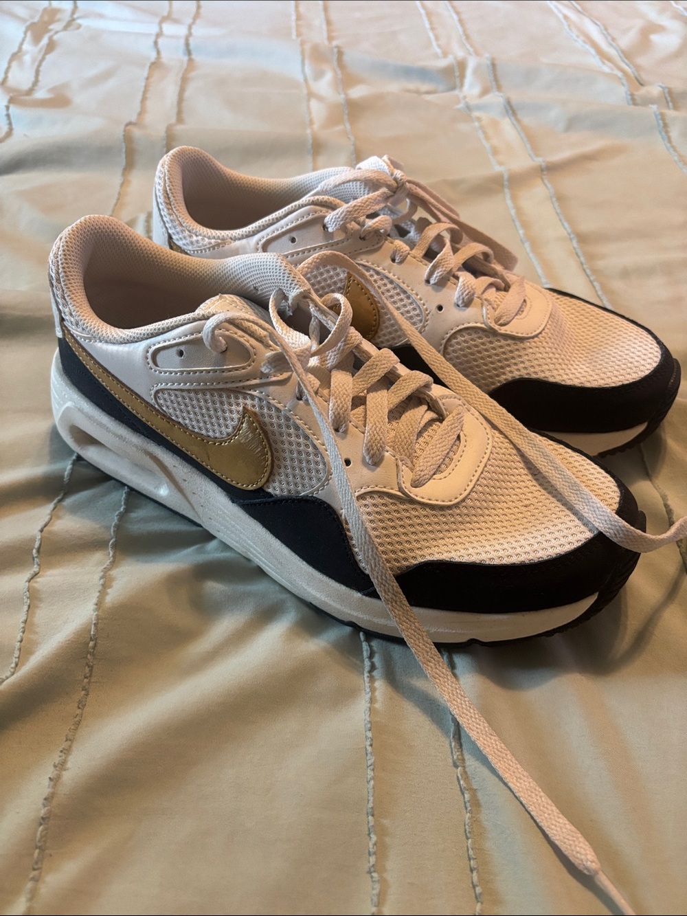 Nike Women’s White and Black Sneakers with Gold Swoosh